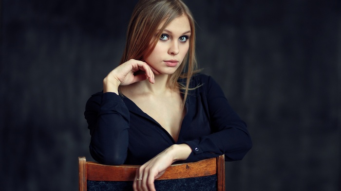 Woman in black shirt sitting on a chair