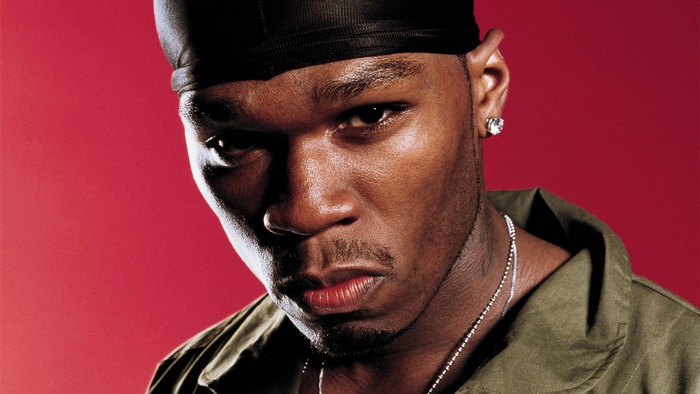 50 Cent wearing a durag and olive jacket