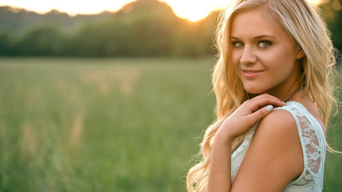 Woman in a field at sunset