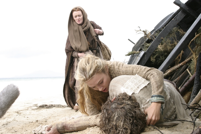 Sophia Myles on a beach with shipwreck debris