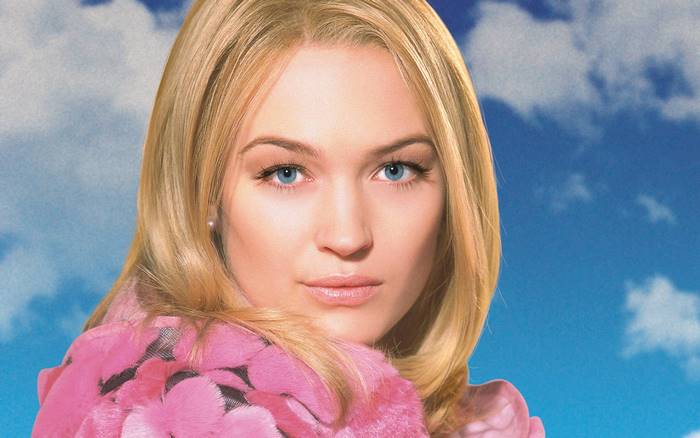 Sophia Myles in pink fur coat against blue sky