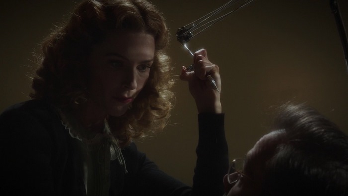 Bridget Regan in a dimly lit room