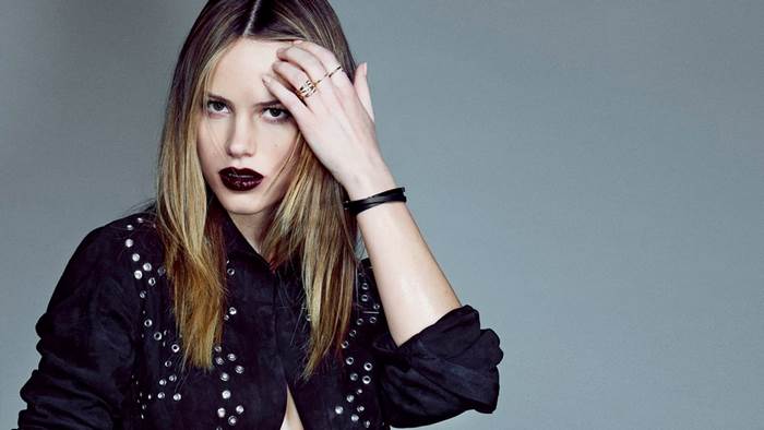 Halston Sage with dark lipstick and studded jacket