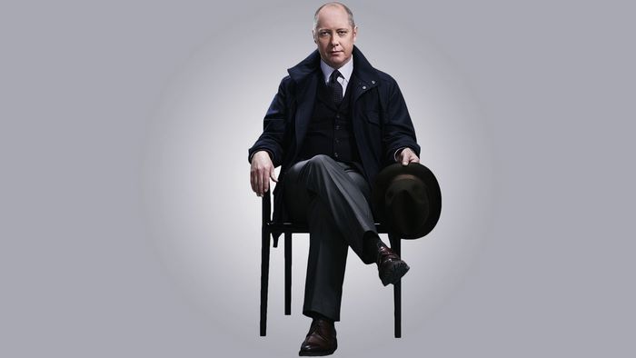 James Spader sitting with a hat