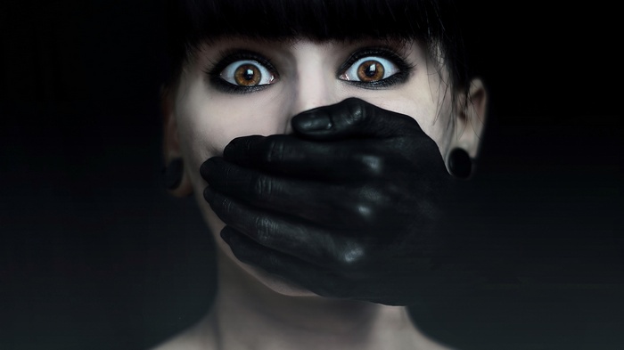 Woman with hand over mouth