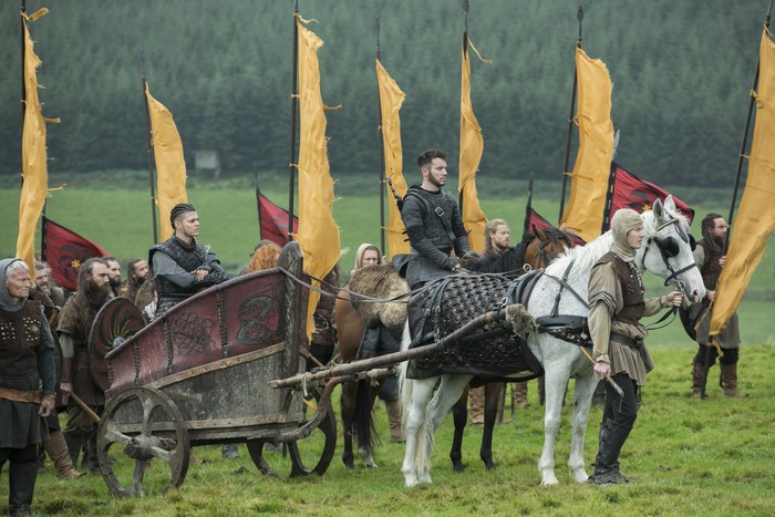 Vikings characters with flags and chariot