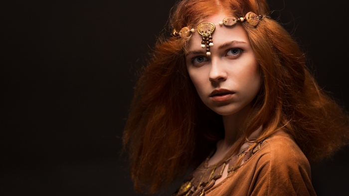 Woman with red hair and a beaded headband