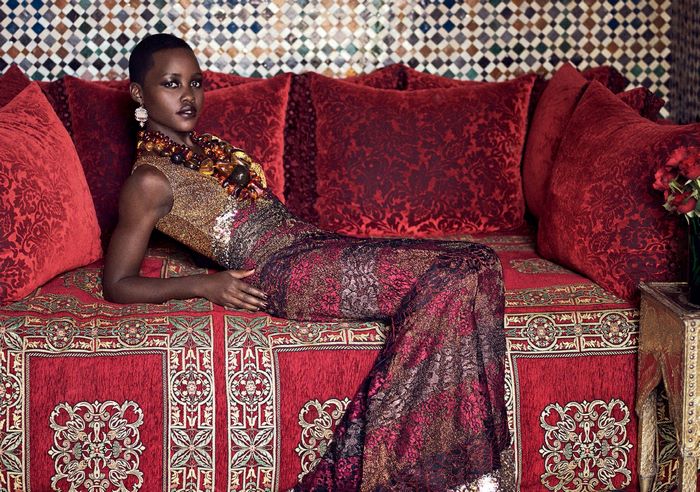Lupita Nyong'o in ornate red and gold setting
