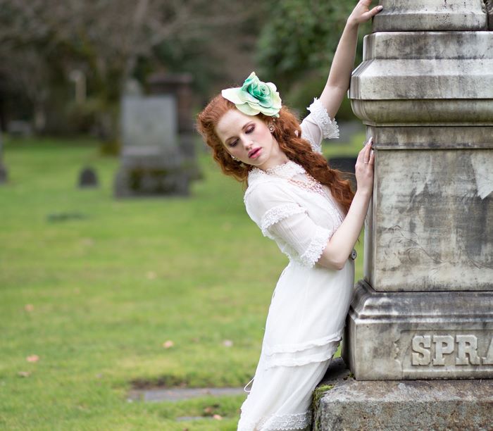Madelaine Petsch in a white dress in a cemetery