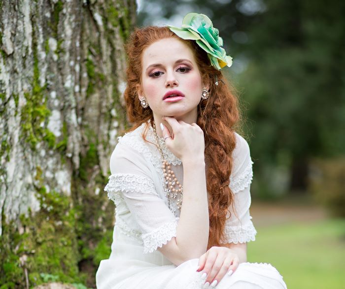 Madelaine Petsch in white dress with flower in hair