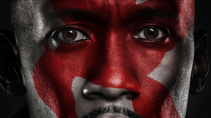 Mahershala Ali with red and silver face paint