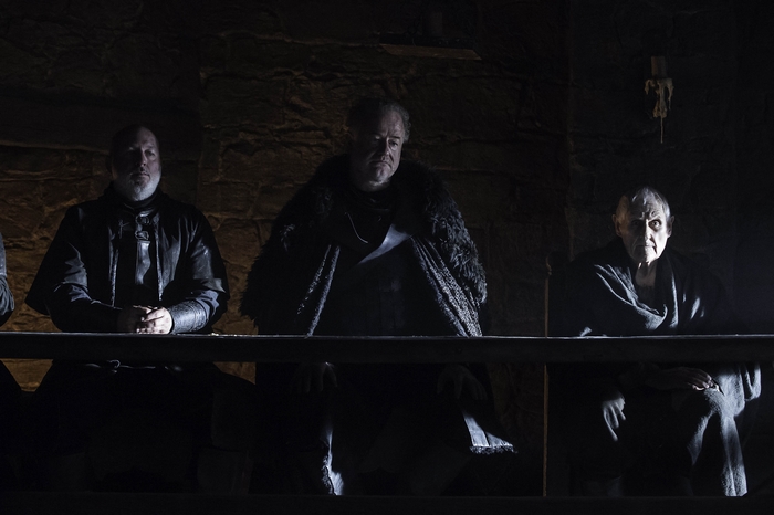 Owen Teale and two other men in dark clothing