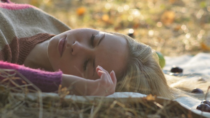 Woman lying on a blanket outdoors
