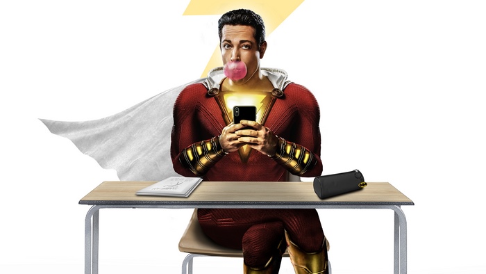 Shazam from DC Comics sitting at a desk