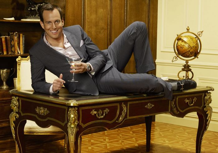 Will Arnett posing on a desk with a martini