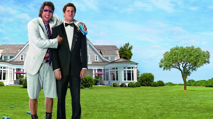 Andy Samberg and Adam Sandler in front of a house