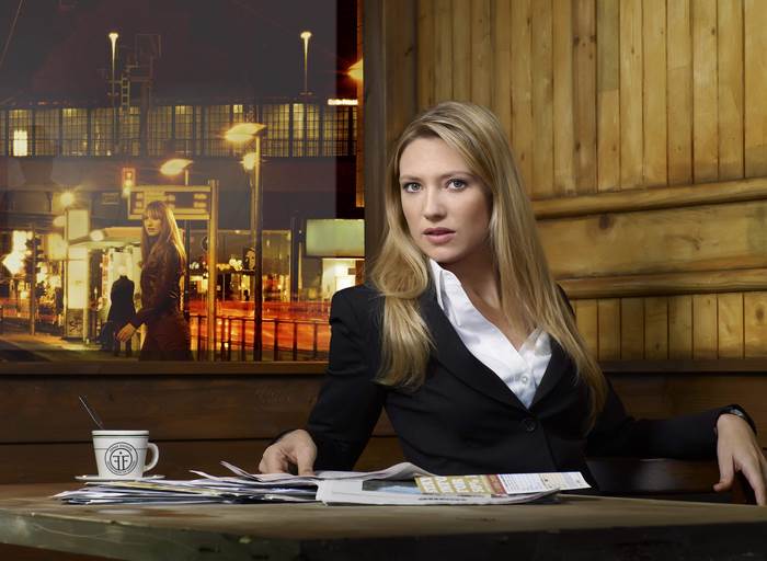 Anna Torv sitting at a table with a coffee cup