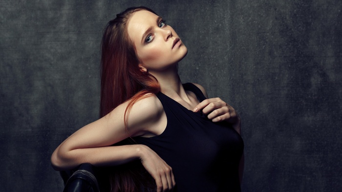 Woman with long red hair in a black dress