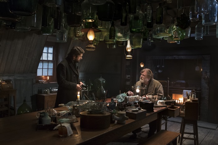 Ben Whishaw in a dimly lit laboratory