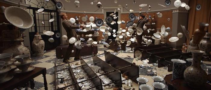 Ben Whishaw in a room with flying dishes