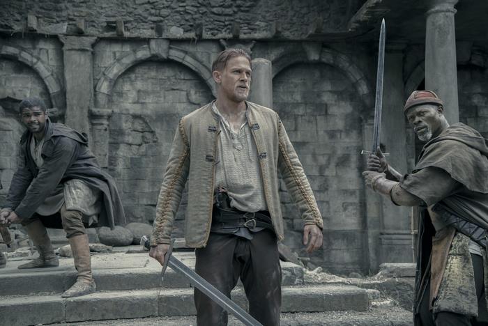 Djimon Hounsou and two men with swords