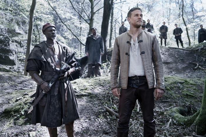 Djimon Hounsou and Charlie Hunnam in a forest