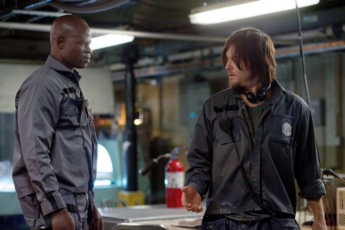 Djimon Hounsou and Norman Reedus in a workshop