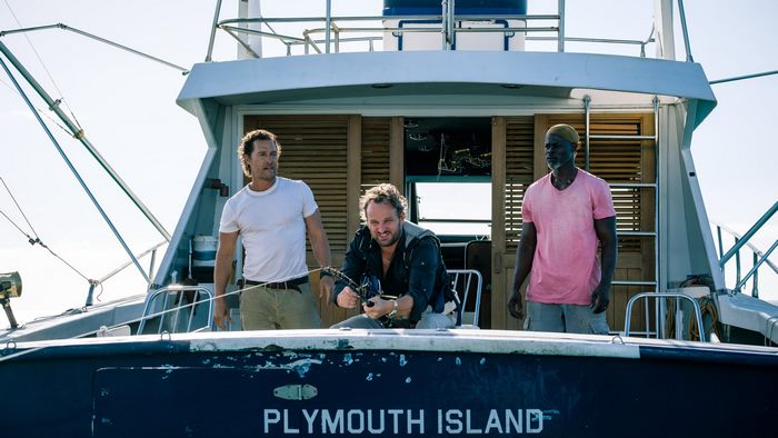 Matthew McConaughey, Scott Adkins, and Djimon Hounsou on a boat