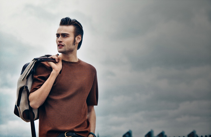 Douglas Booth with a bag over his shoulder