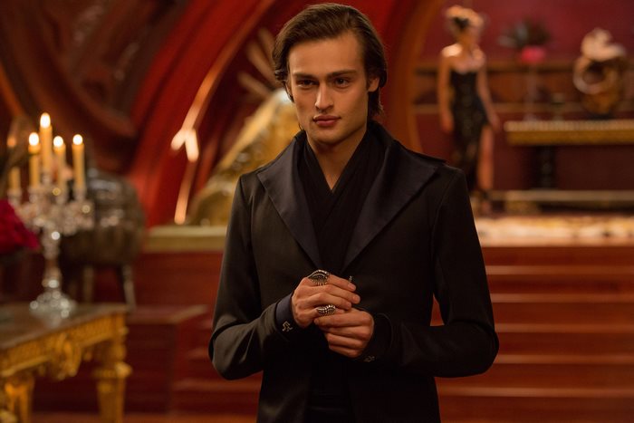 Douglas Booth in a black suit