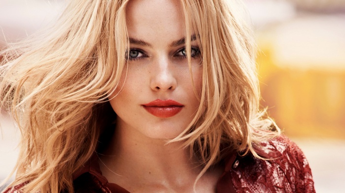 Margot Robbie with blonde hair and red lipstick