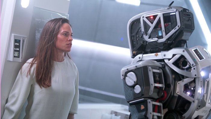 Hilary Swank with a robot