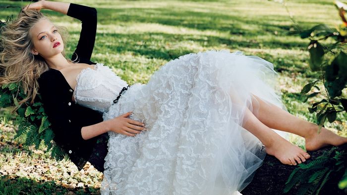 Gemma Ward in a white dress and black cardigan