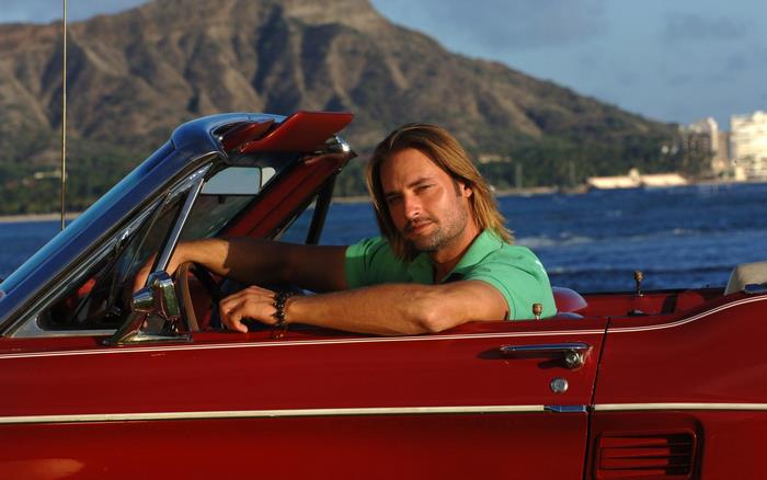 Josh Holloway in a red convertible