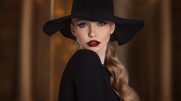 Woman in black hat and dress with red lipstick