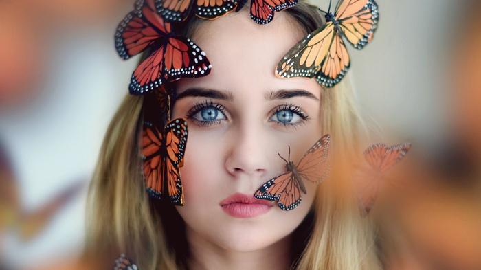 Woman with butterflies on her face