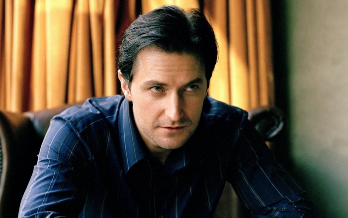 Richard Armitage in a blue striped shirt
