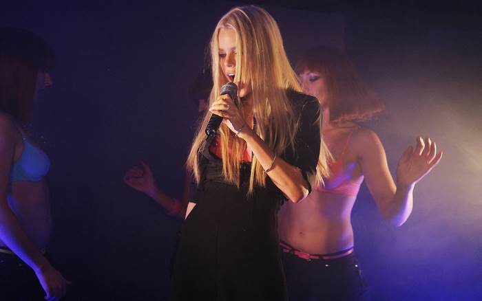 Sophie Monk performing on stage with dancers