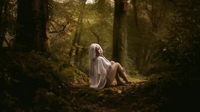 Woman with white hair in a forest
