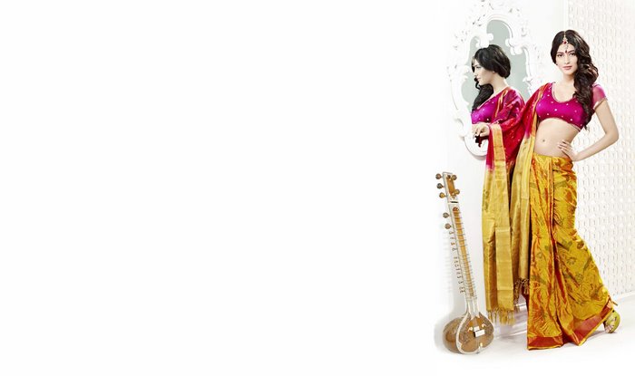 Shruti Haasan in a pink and yellow sari with a sitar