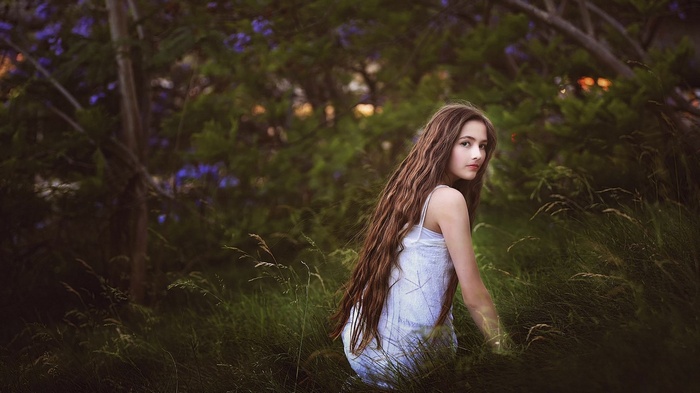 Girl with long hair in a field