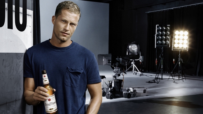 Til Schweiger holding a König Pilsener beer bottle