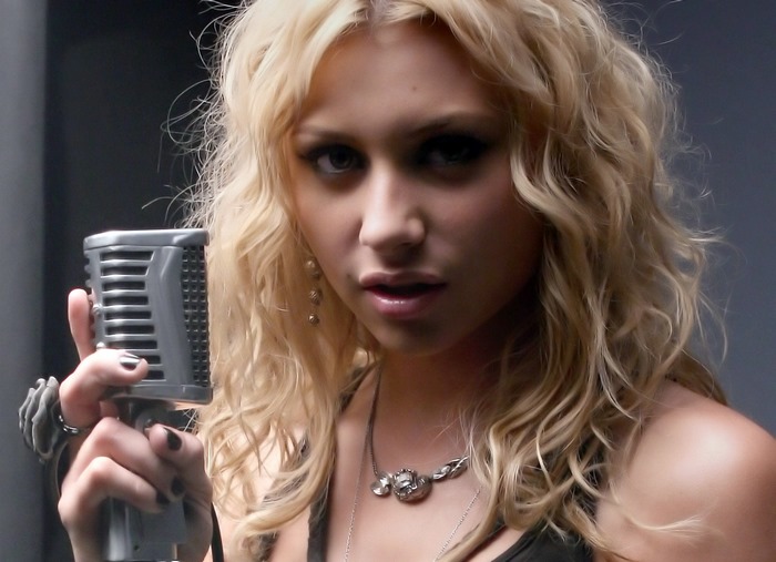 Aly Michalka holding a microphone