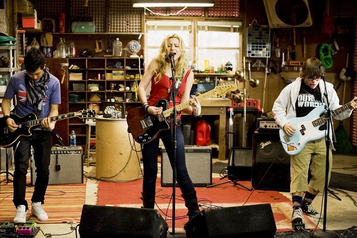 Aly Michalka playing guitar and singing