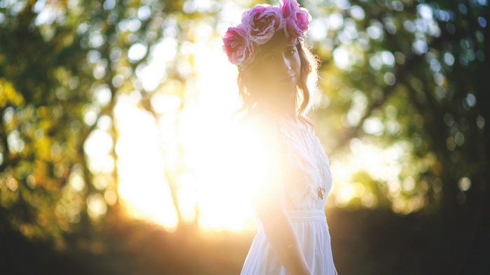 Woman with flower crown in sunlight