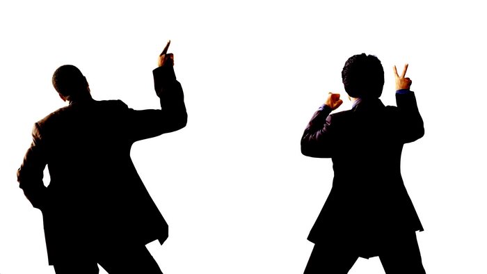 Two men in suits celebrating