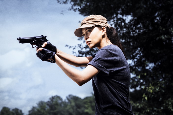 Christian Serratos holding a handgun