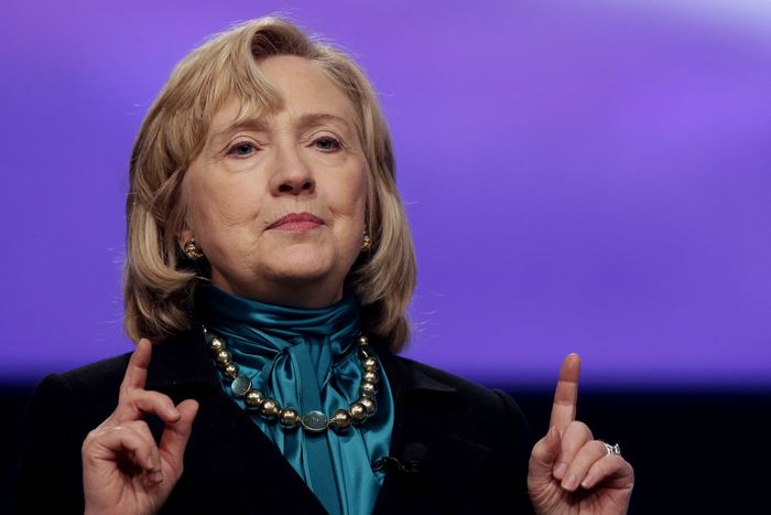 Hillary Clinton speaking with purple background