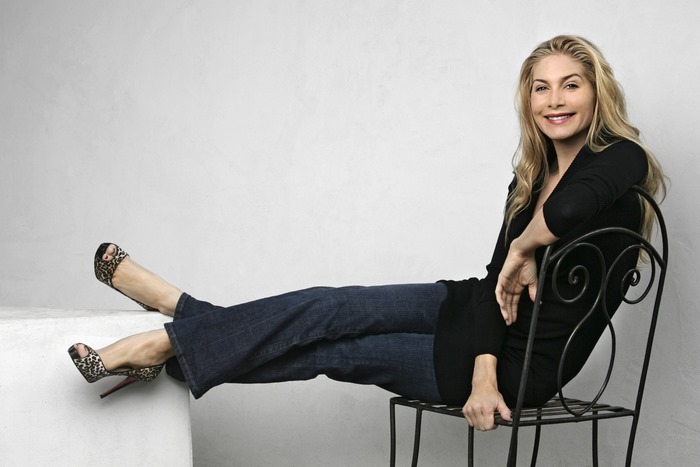 Elizabeth Mitchell sitting on a chair