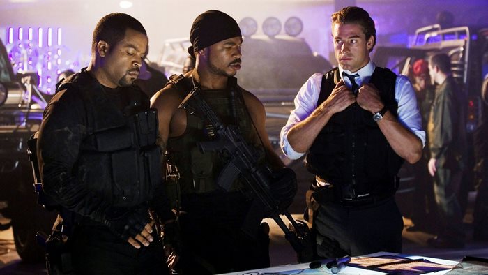 Ice Cube and two men in tactical gear